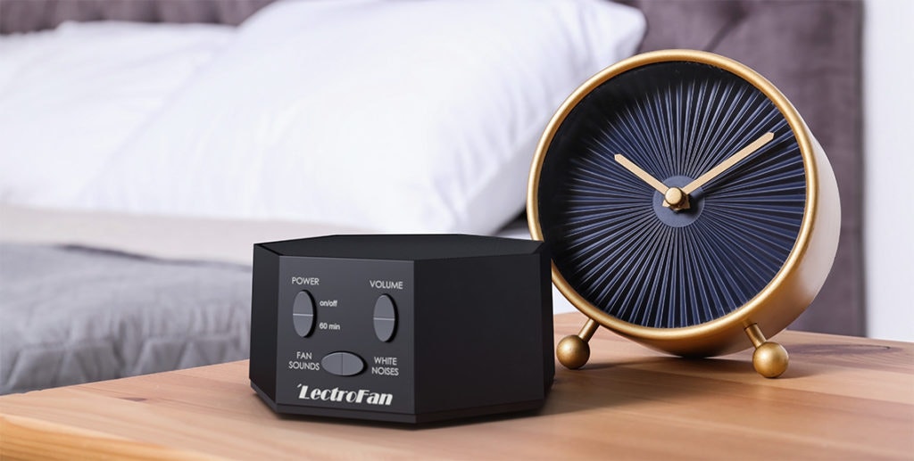A white noise machine and an alarm clock